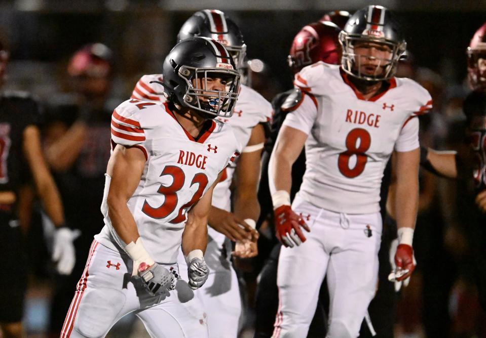 Mountain Ridge’s Cannon Montgomery celebrates after the defense came up with a stop on Herriman as they play at Herriman on Friday, Sept. 29, 2023. | Scott G Winterton, Deseret News