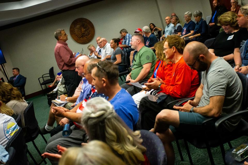 Audience members applaud public comment during the county board meeting Tuesday, May 23, 2023, at the county offices in West Olive.
