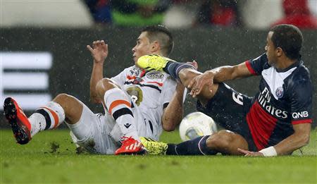 Paris St Germain's Lucas (R) challenges FC Lorient's Wesley Lautoa during their French Ligue 1 soccer match at the Parc des Princes Stadium in Paris November 1, 2013. REUTERS/Benoit Tessier