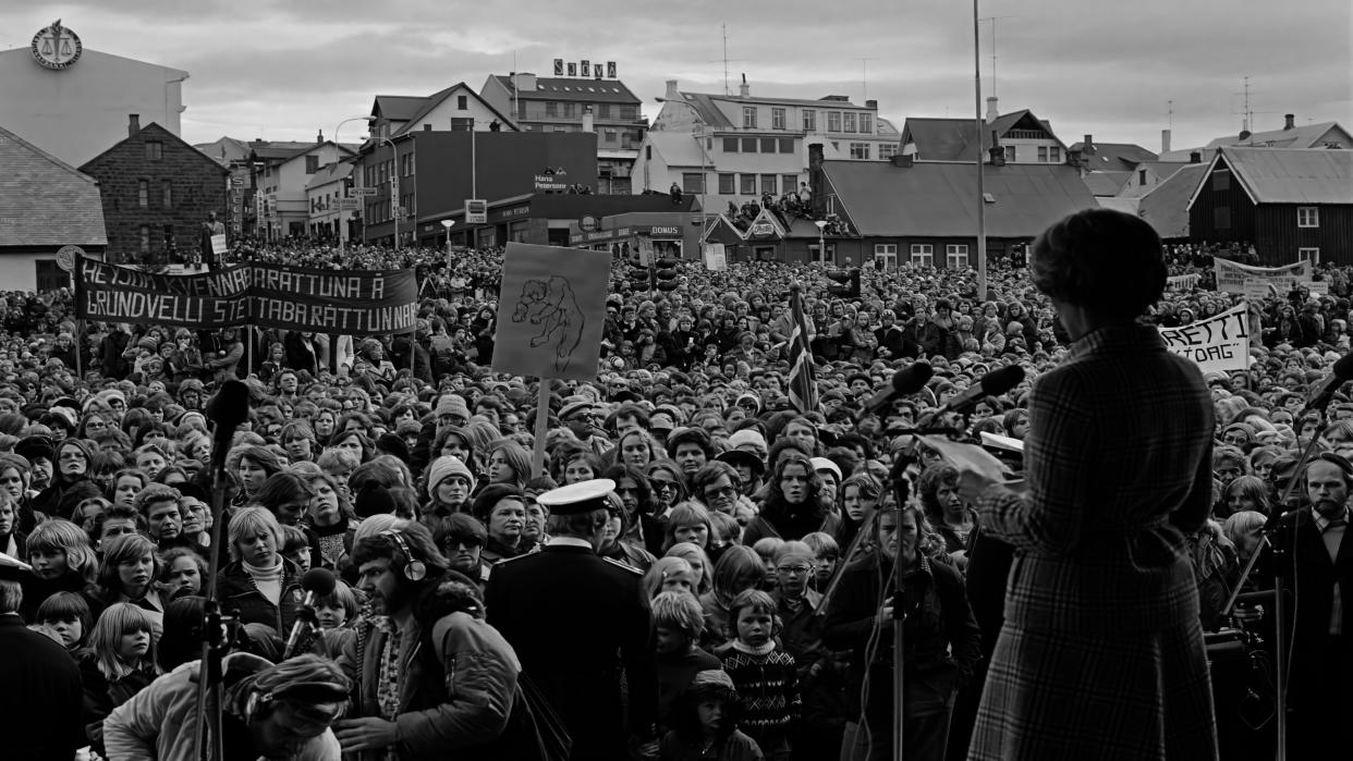 On October 24, 1975, 90% of Iceland’s women took the “day off,” holding demonstrations in villages and towns throughout the country. The gathering in Reykjavik was the largest in Iceland’s history. Activist Gudrun Erlendsdottir is on stage.