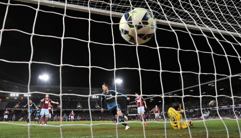 Chelsea's Belgian midfielder Eden Hazard (C) scores the opening goal past West Ham United's Spanish goalkeeper Adrian during their English Premier League football match in Upton Park, East London on March 4, 2015