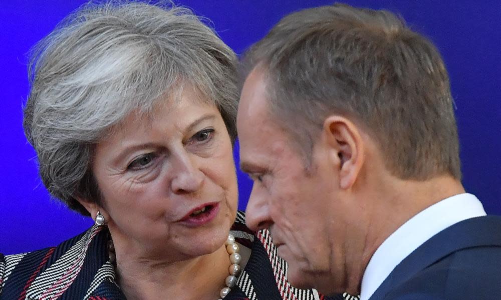 Theresa May speaks with the European council president, Donald Tusk