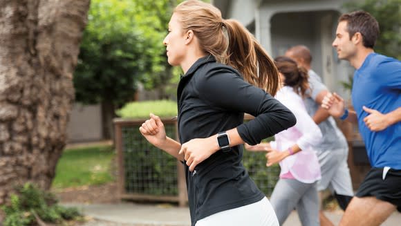 Joggers wearing Fitbit Blaze trackers.