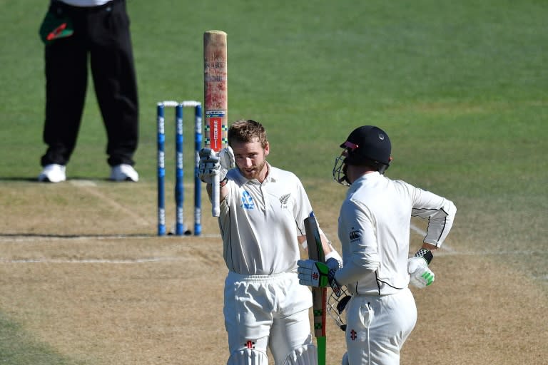 New Zealand's captain Kane Williamson (L) celebrates his century with teammate Henry Nicholls on day five of their first Test match against Bangladesh, at the Basin Reserve in Wellington, on January 16, 2017