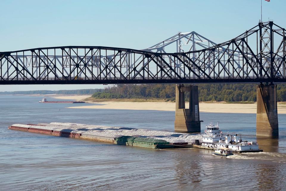 barge passes under bridge on mississippi river low waters