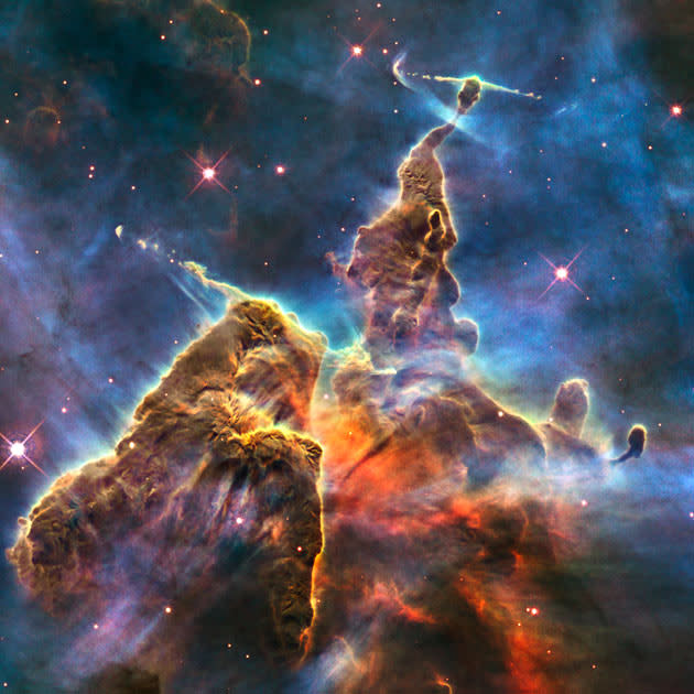 This handout composite image by NASA/ESA from the Hubble telescope, taken between February 1-2, 2010 and obtained on April 23, 2010 shows an image of a pillar of star birth, three light-years high, depicting how scorching radiation and fast winds (streams of charged particles) from super-hot newborn stars in the nebula are shaping and compressing the pillar, causing new stars to form within it. This pinnacle lies within a stellar nursery called the Carina Nebula, located 7500 light-years away in the southern constellation of Carina. The image celebrates the 20th anniversary of Hubble's launch and deployment into an orbit around the Earth. The colours correspond to the glow of oxygen (blue), hydrogen and nitrogen (green), and sulphur (red). AFP PHOTO / NASA - ESA - M. Livio