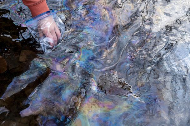 PHOTO: Olivia Holley, 22, and Taylor Gulish, 22, collect water samples from Leslie Run creek on February 25, 2023 in East Palestine, Ohio. (Michael Swensen/Getty Images)