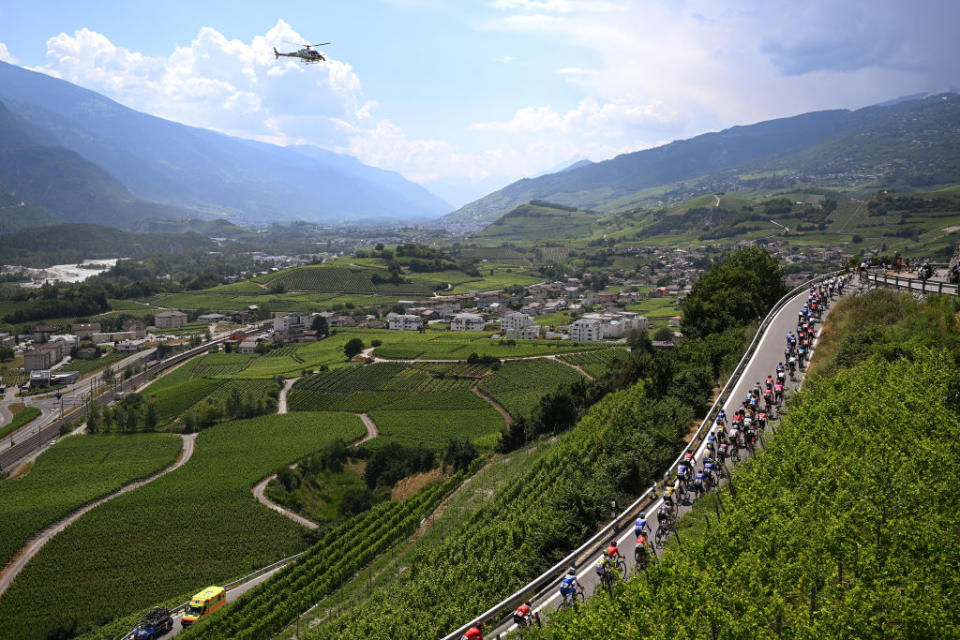 LEUKERBAD SWITZERLAND  JUNE 14 A general view of the peloton passing through a vineyards landscape during the 86th Tour de Suisse 2023 Stage 4 a 1525km stage from Monthey to Leukerbad 1367m  UCIWT  on June 14 2023 in Leukerbad Switzerland Photo by Dario BelingheriGetty Images