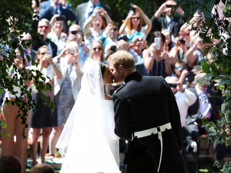 The newlyweds pucker up on the steps of St George’s Chapel (WPA Pool/Getty)