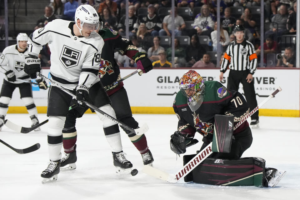 Arizona Coyotes goaltender Karel Vejmelka (70) makes the save against Los Angeles Kings left wing Pierre-Luc Dubois (80) in the first period during an NHL hockey game, Friday, Oct. 27, 2023, in Tempe, Ariz. (AP Photo/Rick Scuteri)