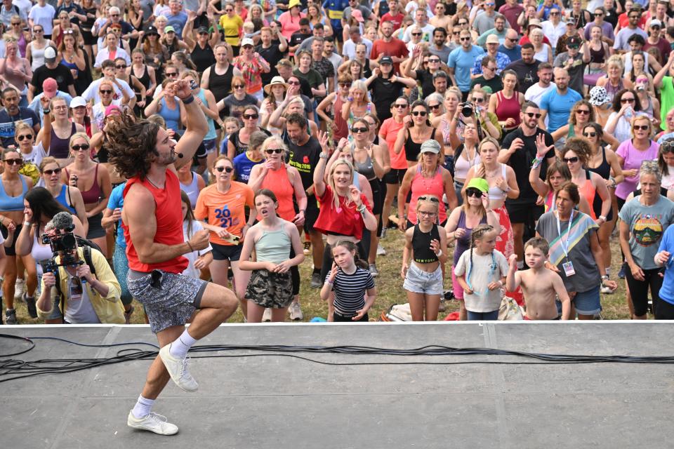 Knees up! Joe Wicks instructs the crowd as he leads a Glastonbury workout (Getty Images)