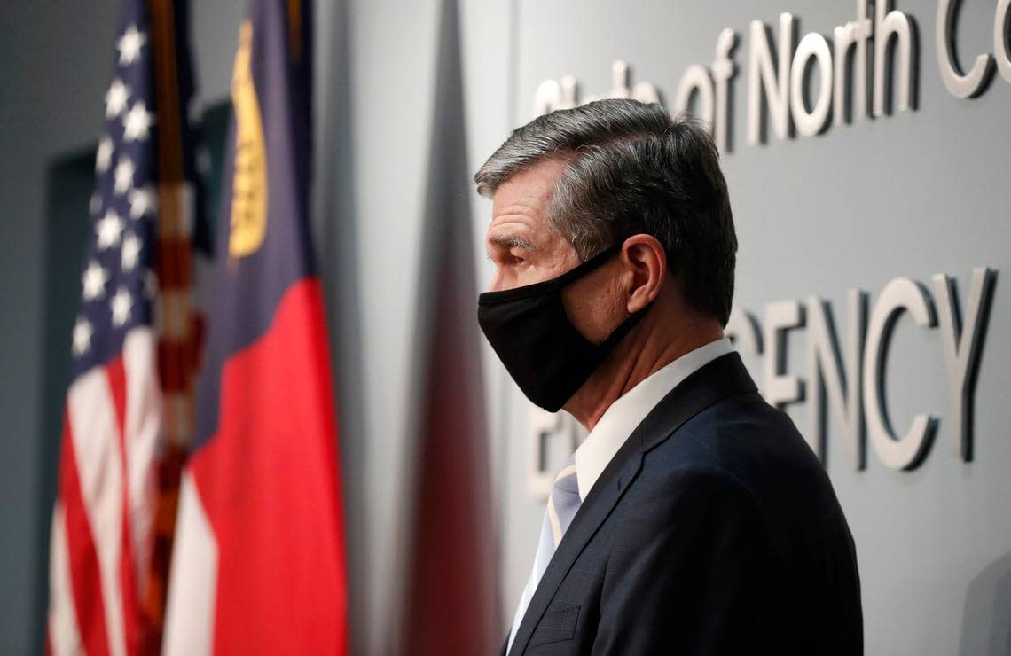 In this file photo from December 2020, Gov. Roy Cooper listens during a briefing at the Emergency Operations Center in Raleigh, N.C. A new law starting Jan. 1, 2022, changes the Emergency Management Act to limit the duration of states of emergency without agreement from the Council of State or General Assembly.