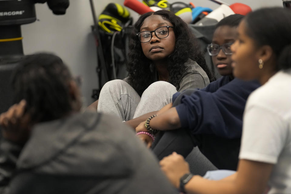 Hillary Amofa listens to others member of the Lincoln Park High School step team after school Friday, March 8, 2024, in Chicago. When she started writing her college essay, Amofa told the story she thought admissions offices wanted to hear. She wrote about being the daughter of immigrants from Ghana, about growing up in a small apartment in Chicago. She described hardship and struggle. Then she deleted it all. "I would just find myself kind of trauma-dumping," said the 18 year-old senior, "And I'm just like, this doesn't really say anything about me as a person." (AP Photo/Charles Rex Arbogast)