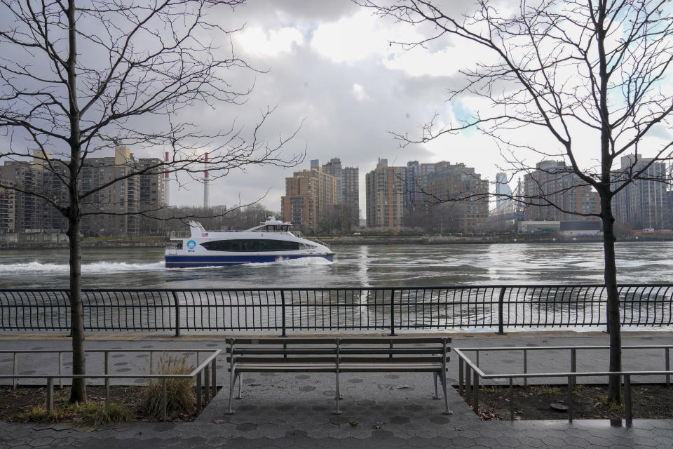 A commuter ferry makes its way down the East River on the the Upper East Side of the Manhattan borough of New York on Friday, Jan. 6, 2023, where woolly mammoth tusks were allegedly dumped in the mid 1900s. (AP Photo/Mary Altaffer)
