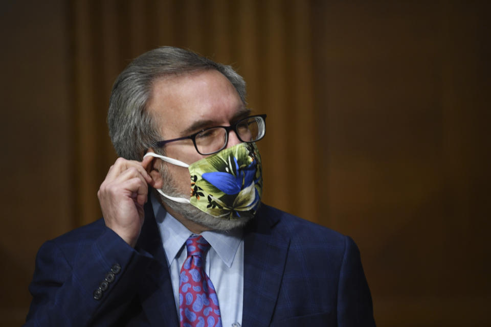 Andrew Wheeler, administrator of the Environmental Protection Agency, adjusts his mask at a hearing during a Senate Environment and Public Works Committee oversight hearing to examine the Environmental Protection Agency, Wednesday, May 20, 2020 on Capitol Hill in Washington. (Kevin Dietsch/Pool via AP)