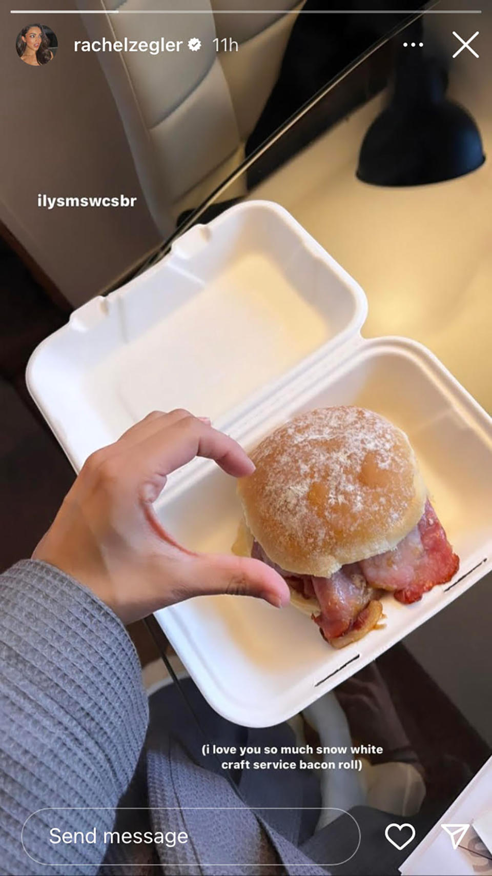 Rachel Zegler showing off bacon roll from Snow White set.