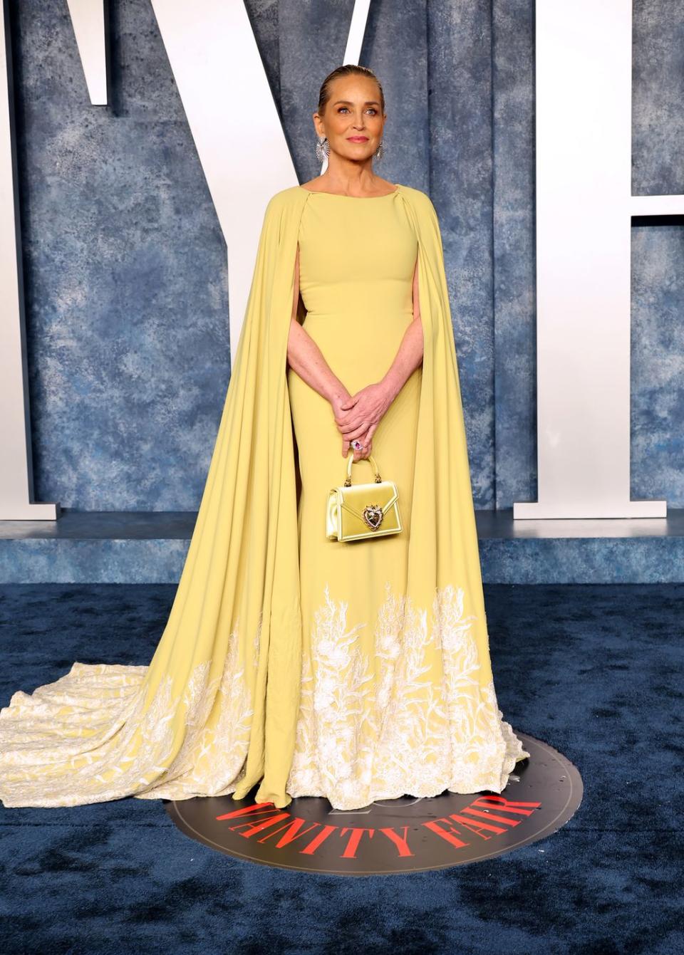 Sharon Stone looks stunning in yellow caped dress for Oscars after party