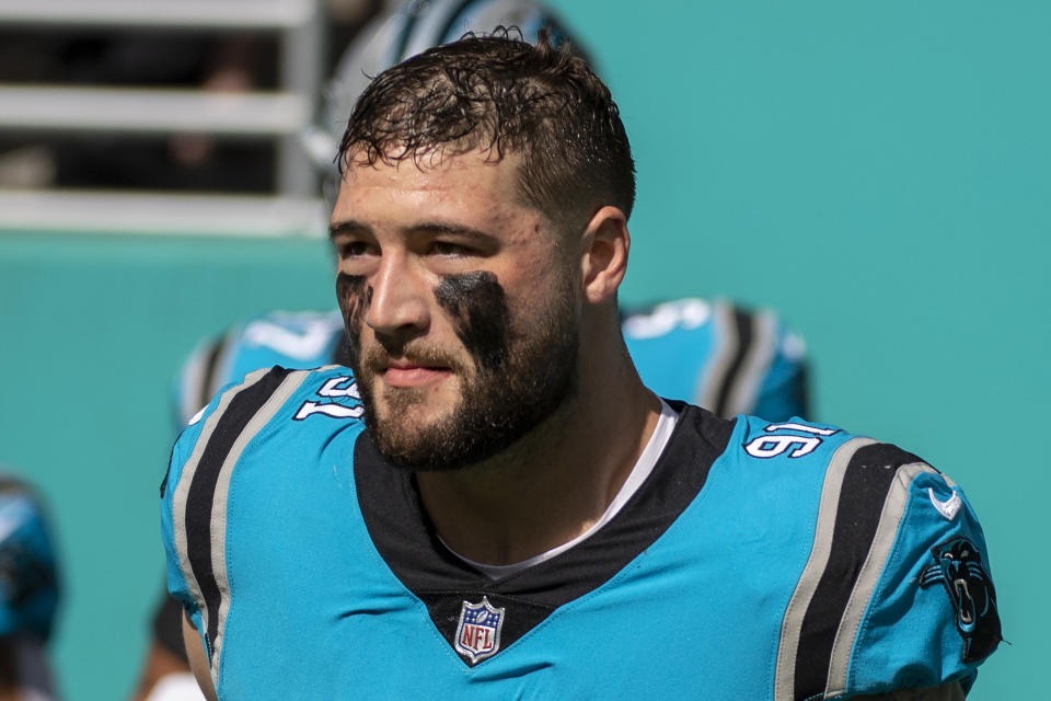 FILE - Carolina Panthers defensive end Morgan Fox (91) runs onto the field before an NFL football game against the Miami Dolphins, Sunday, Nov. 28, 2021, in Miami Gardens, Fla. The Panthers released cornerback A.J. Bouye and defensive end Morgan Fox in salary cap moves Monday, March 14, 2022, opening more money for their potential pursuit of Houston Texans quarterback Deshaun Watson. (AP Photo/Doug Murray, File)