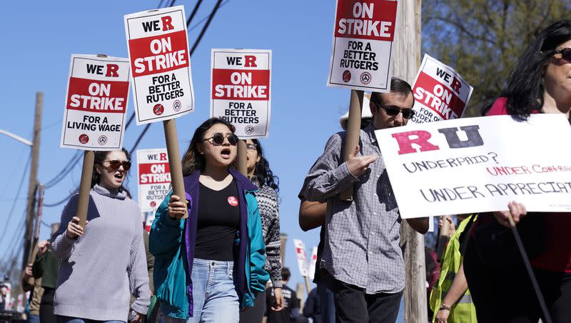 Strikers march in front of Rutgers University in New Brunswick, N.J., Monday, April 10, 2023. Thousands of professors, part-time lecturers and graduate student workers at New Jersey’s flagship university have gone on strike — the first such job action in the school’s 257-year history.