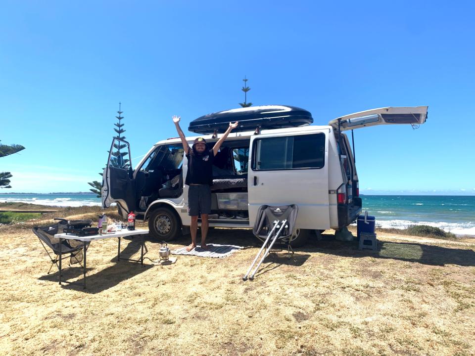 the writer's van with trunk and sides popped open and a table set up on the side