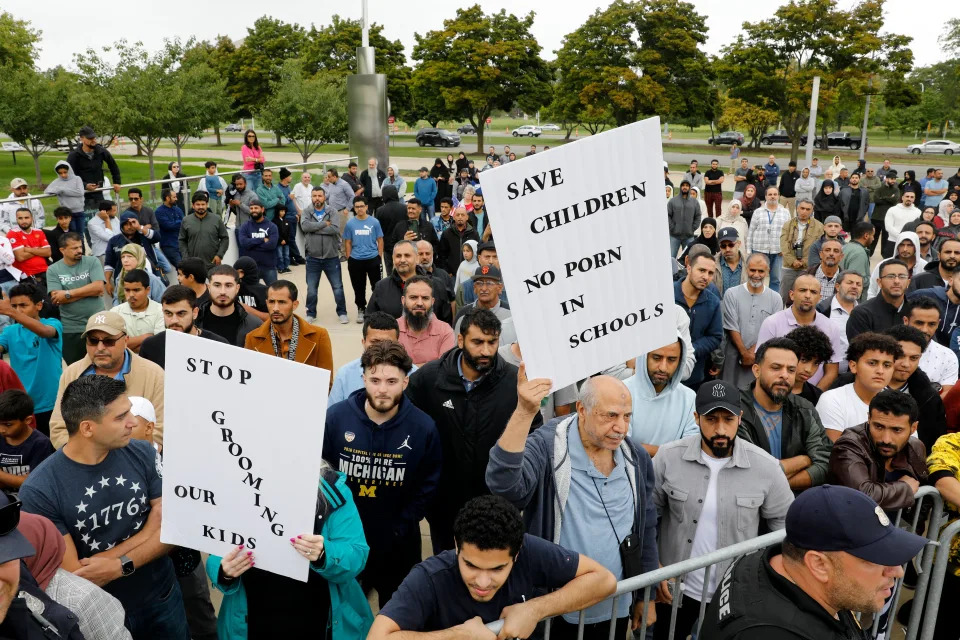 Protesters who support banning books gather outside of the Henry Ford Centennial Library in Dearborn, Mich.