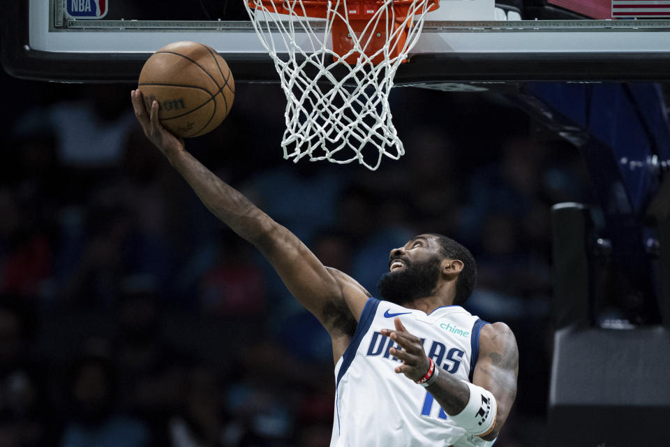 Dallas Mavericks guard Kyrie Irving (11) drives to the basket during the first half of an NBA basketball game against the Charlotte Hornets Tuesday, April 9, 2024, in Charlotte, N.C. (AP Photo/Jacob Kupferman)