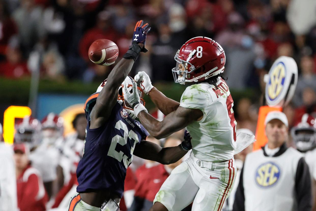 Nov 27, 2021; Auburn, Alabama, USA; Auburn Tigers cornerback Roger McCreary (23) breaks up a pass intended for Alabama Crimson Tide wide receiver John Metchie III (8) in the fourth quarter at Jordan-Hare Stadium.  Mandatory Credit: John Reed-USA TODAY Sports