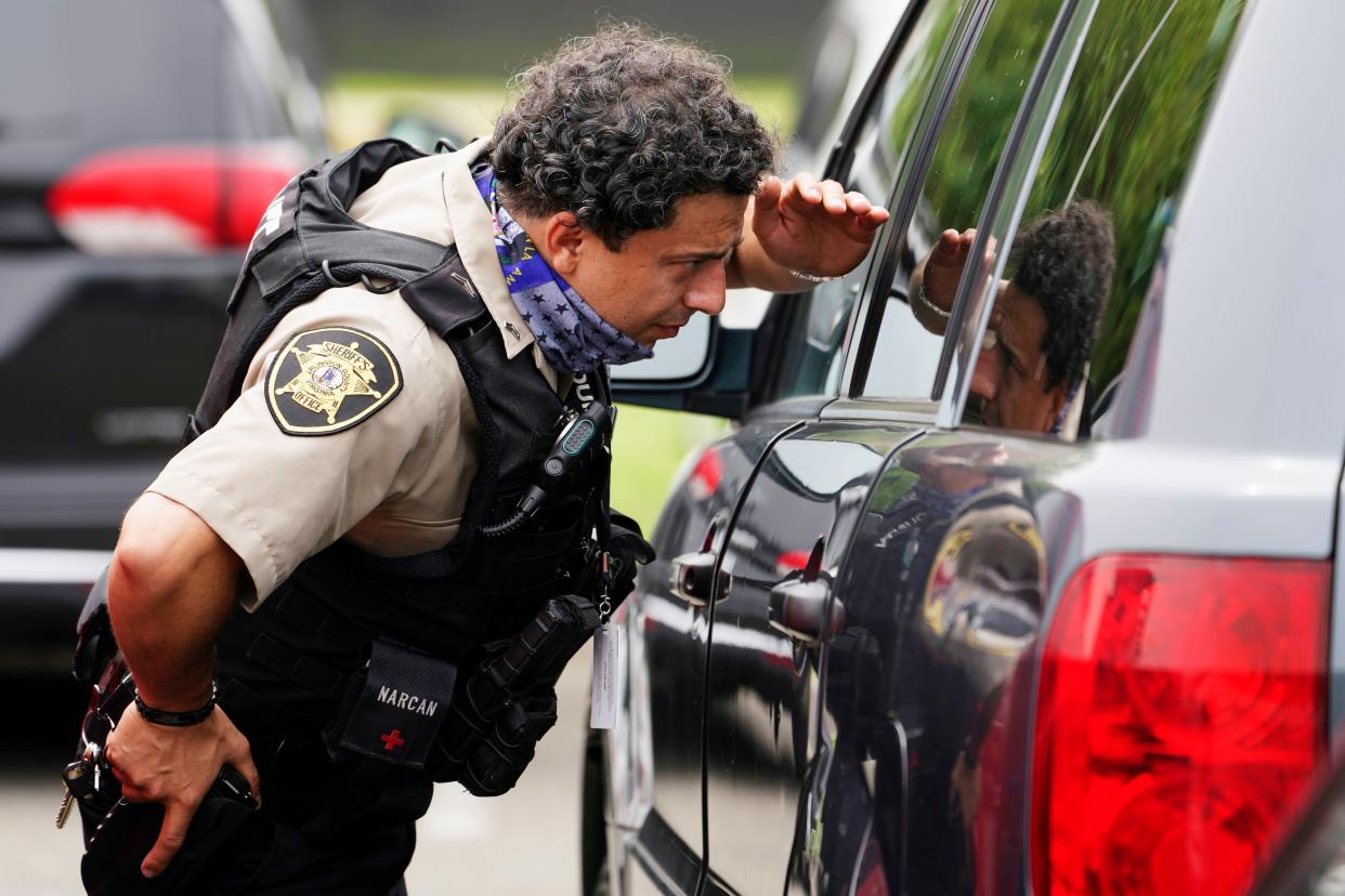 A police officer looks at a vehicle outside the Pentagon on Tuesday.