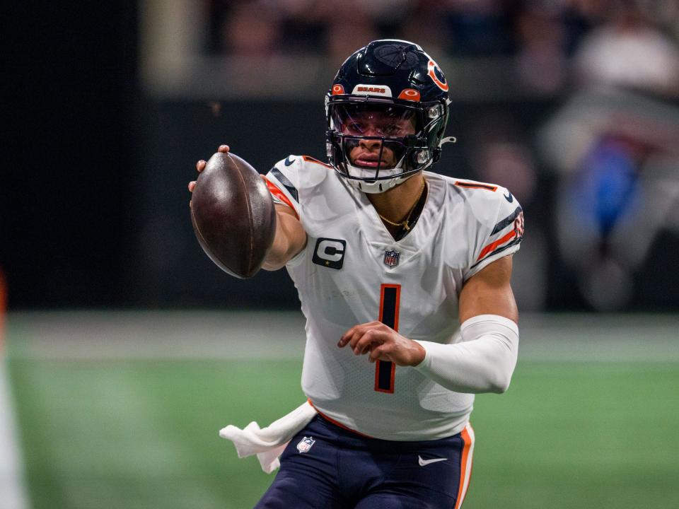 Justin Fields runs with the ball against the Atlanta Falcons.