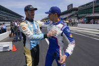 Agustin Canapino, left, of Argentina, talks with Alex Palou, of Spain, before practice for the Indianapolis 500 auto race at Indianapolis Motor Speedway, Monday, May 22, 2023, in Indianapolis. (AP Photo/Darron Cummings)