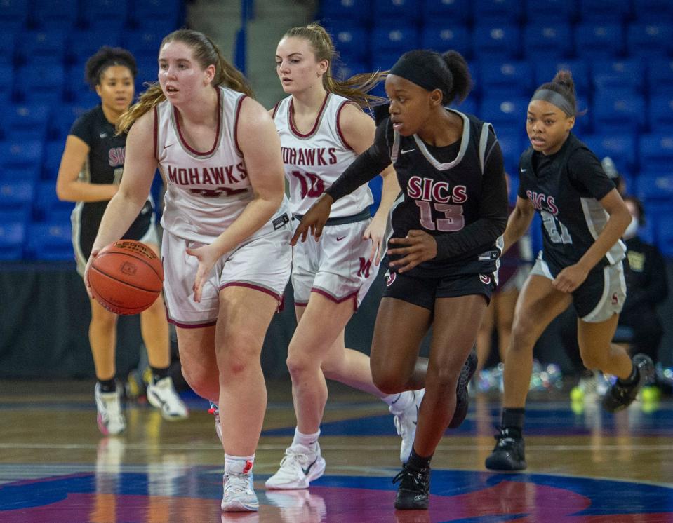 Millis High School girls basketball junior Hailey Bassett starts a fast break against Springfield International Charter School in the 2023 Div. 5 state finals at the Tsongas Center in Lowell, March 19, 2023.