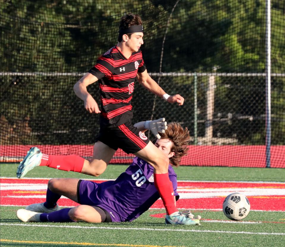 Tappan Zee's Brady Jacobs runs over Rye goalkeeper Max Crothall during their boys soccer game at Tappan Zee High School, Sept. 19, 2023.
