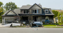 This photo shows a damaged house after a plane crashed in Payson, Utah, Monday, Aug. 13, 2018. A Utah man flew the small plane into his own house early Monday just hours after he had been arrested for assaulting his wife in a nearby canyon where the couple went to talk over their problems, authorities said. (Leah Hogsten/The Salt Lake Tribune via AP)