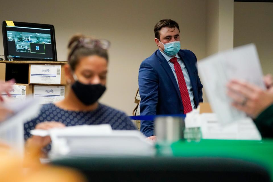 A Republican observer watches as Lehigh County workers count ballots as vote counting in the general election continues, Thursday, Nov. 5, 2020, in Allentown, Pa.