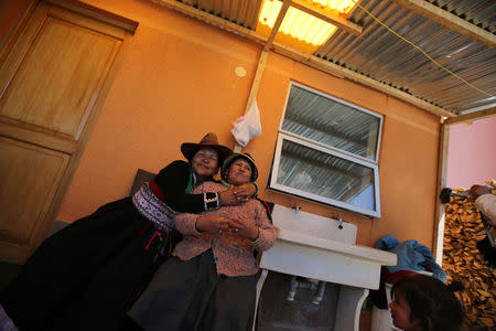 Monica Lima (L) and a friend celebrate days after Monica's wedding to Reynaldo Llanqui, at her house in the town of Nueva Fuerabamba in Apurimac, Peru, October 3, 2017. REUTERS/Mariana Bazo