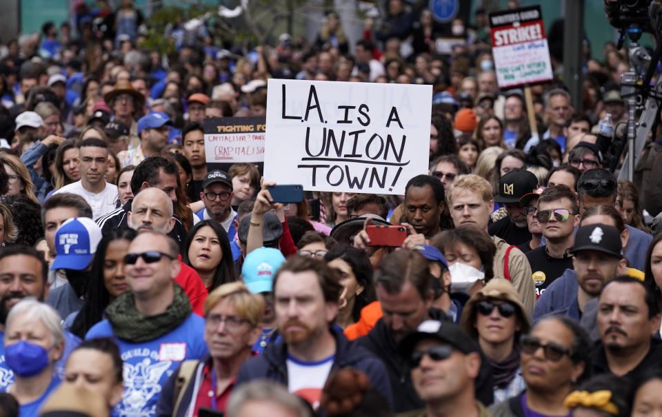 Crowd members listen to a speaker during the "Unions Strike Back" rally, Friday, May 26, 2023, near Crypto.com Arena in Los Angeles. Union members from the tourism and hospitality, Hollywood, public sector, education and logistics industries mobilized for a display of collective solidarity. (AP Photo/Chris Pizzello)