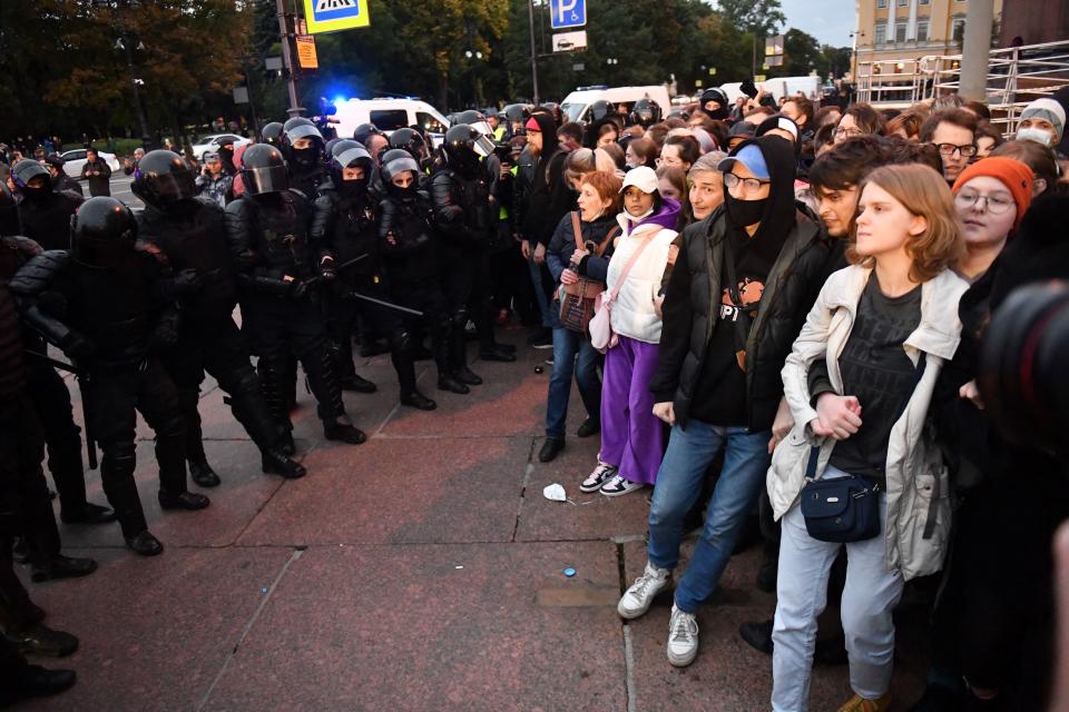 Police officers confront demonstrators in St. Petersburg