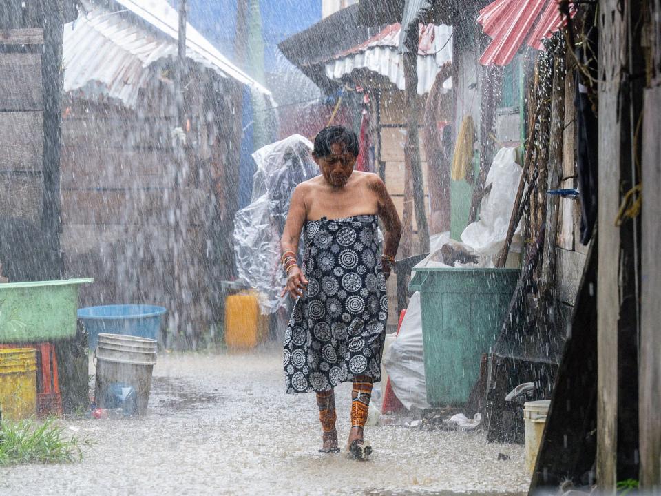 A Guna woman walks under the rain on the island of Carti Sugtupu.