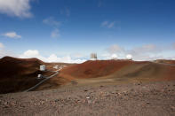 FILE - In this Aug. 31, 2015, file photo, observatories and telescopes sit atop Mauna Kea, Hawaii's tallest mountain and the proposed construction site for a new $1.4 billion telescope, near Hilo, Hawaii. After years of protests and legal battles, Hawaii officials have announced that a massive telescope which will allow scientists to peer into the most distant reaches of our early universe will be built on a volcano that some consider sacred. (AP Photo/Caleb Jones, File)