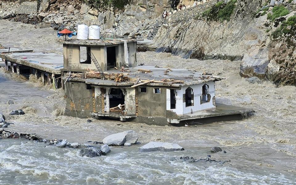 A damaged mosque is surrounded by floodwaters in Bahrain, Pakistan. (AP Photo/Sherin Zada)