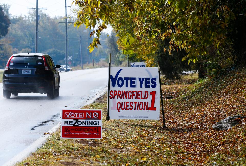 Signs along South Lone Pine Avenue in the Galloway Neighborhood, both for and against Question 1, on Wednesday, Oct. 12, 2022.