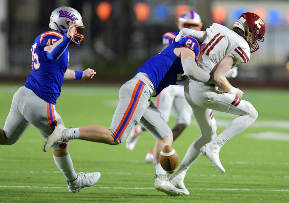 Episcopal Eagles's Nate Blair (11) gets stripped of the ball during a hit by Bolles Bulldogs' Trent Carter (21) during second quarter action. The Bulldogs recovered the fumble. The Episcopal Eagles were hosted by The Bolles School Bulldogs at Skinner-Barco Stadium in the FHSAA Region 1-2M high school football quarterfinal game Friday, November 11, 2022. Bolles went into half time with a 28 to 0 lead.