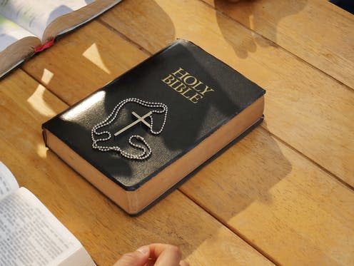 <span class="caption">Documents released by Church of England reinforce their teaching that 'homosexuality is incompatible with scripture'.</span> <span class="attribution"><a class="link " href="https://www.shutterstock.com/image-photo/silver-cross-on-holy-bible-brown-1542097025" rel="nofollow noopener" target="_blank" data-ylk="slk:kaninw/Shutterstock;elm:context_link;itc:0;sec:content-canvas">kaninw/Shutterstock</a></span>