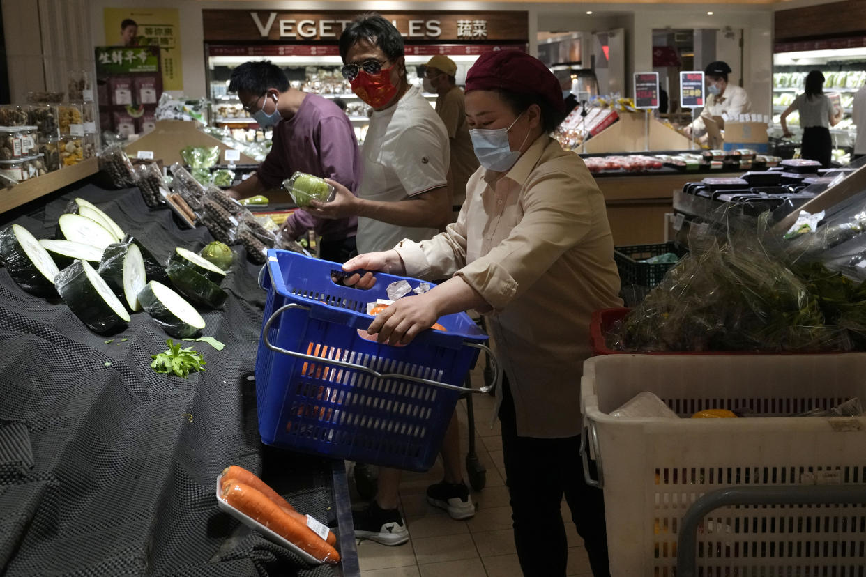 Residents wearing masks shop at a supermarket in the Chaoyang district of Beijing, Monday, April 25, 2022. Mass testing started Monday in Chaoyang district, home to more than 3 million people in the Chinese capital, following a fresh COVID-19 outbreak. (AP Photo/Ng Han Guan)