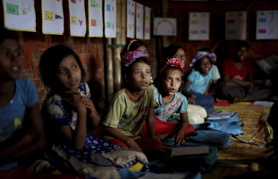 FILE- In this Aug. 27, 2018, file photo, Rohingya refugee children attend a UNICEF run school in Balukhali refugee camp, Bangladesh. Authorities in Bangladesh in partnership with the United Nations will expand educational programs for hundreds of thousands of Muslim Rohingya children living in refugee camps who are currently receiving only basic lessons, officials said Wednesday, Jan. 29, 2020. (AP Photo/Altaf Qadri, File)