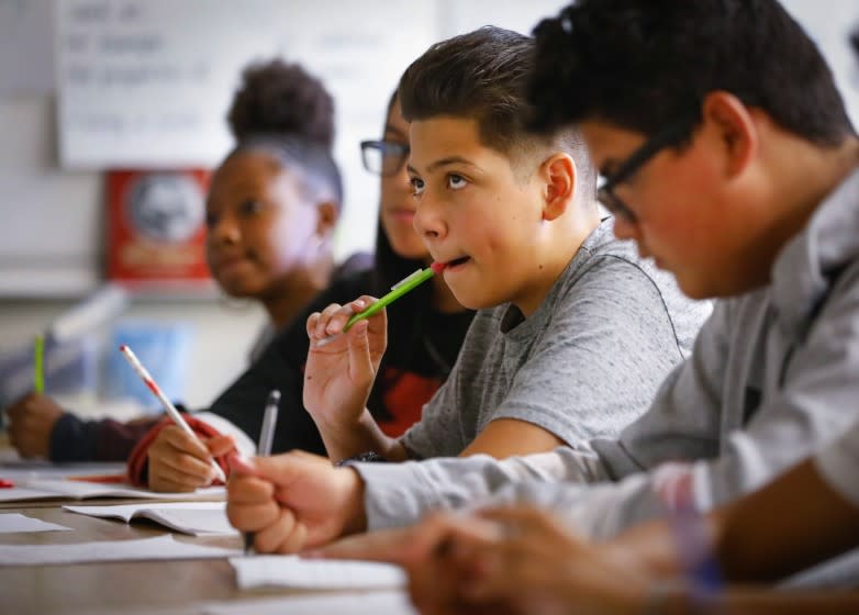 Howard Lipin  U-T Eighth-grade student Domanick Castro (center) and his classmates participate in Glenn Lloyd's class at Wilson Middle School.