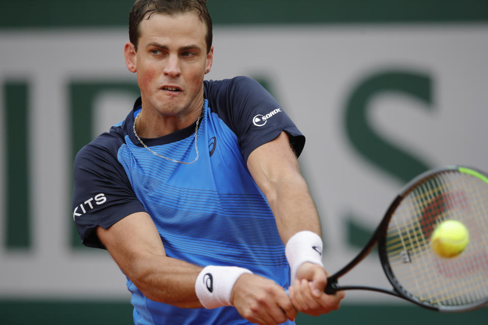 Canada's Vasek Pospisil plays a shot against Italy's Matteo Berrettini in the first round match of the French Open tennis tournament at the Roland Garros stadium in Paris, France, Tuesday, Sept. 29, 2020. (AP Photo/Christophe Ena)