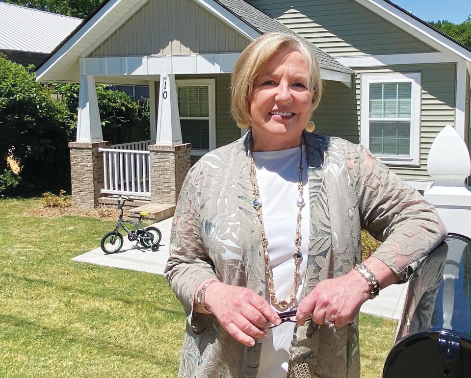 Lorain Crowl, in front of a home built by United Housing Connections in 2021. The home already has its first tenant.