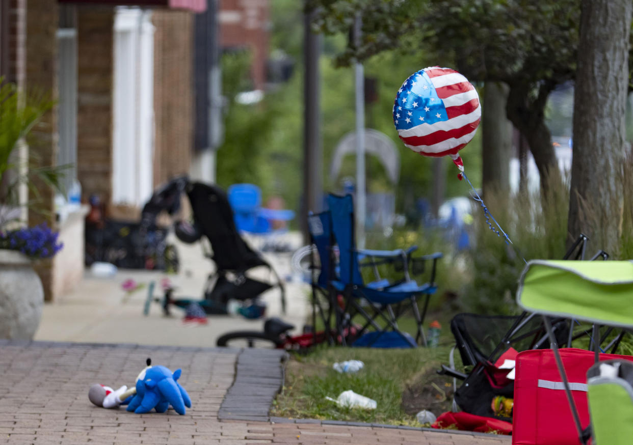 Chairs, strollers and balloons at the scene of a mass shooting on the Fourth of July parade route in Highland Park, Ill.