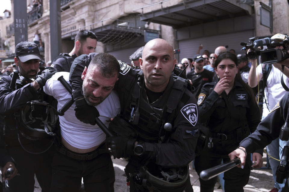 Israeli police detain a man during the funeral for slain Al Jazeera veteran journalist Shireen Abu Akleh in the Old City of Jerusalem, Friday, May 13, 2022. Abu Akleh, a Palestinian-American reporter who covered the Mideast conflict for more than 25 years, was shot dead Wednesday during an Israeli military raid in the West Bank town of Jenin.(AP Photo/Mahmoud Illean)